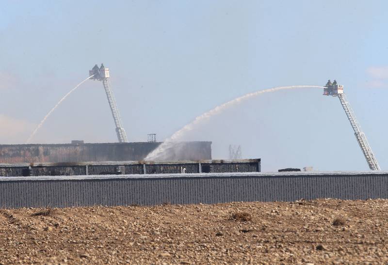Firefighters work the scene of a structure fire on Wednesday, Oct. 8, 2025 at Marquis Energy in Hennepin. The fire was upgraded to a 5th alarm dispatching the (MABAS) Mutual Aid Box Alarm System. The fire broke out around 11a.m.