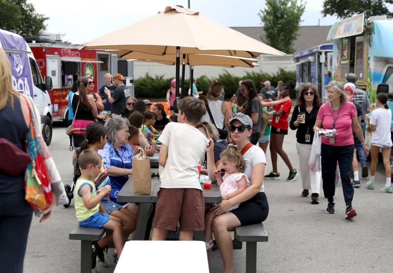 Shoppers browse the vendors at the Elmhurst Farmer’s Market on Wednesday, July 7, 2025 at the market’s new location parking lot of Elmhurst Christian Reformed Church.