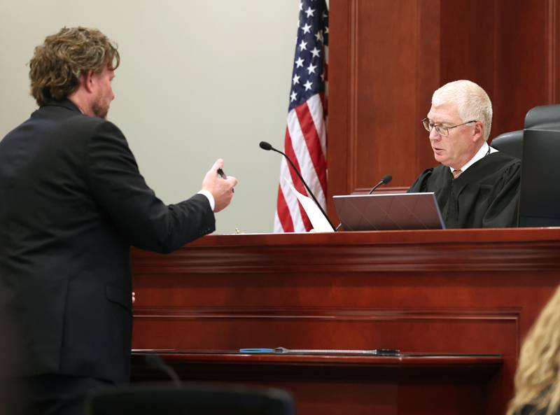 Lead prosecutor Scott Schwertley hands some information off to Circuit Court Judge Philip Montgomery during the sentencing hearing for former police officer James Corralejo Thursday, July 17, 2025, at the DeKalb County Courthouse in Sycamore. Corralejo was sentenced to four years in prison for a Class 2 felony count of driving under the influence of alcohol causing death for a 2023 crash that killed DeKalb woman Graciela Reza Contreras.