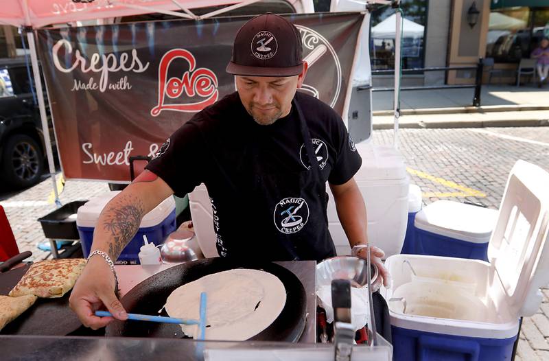 Gustavo Cruz from Magic Crepes makes a crepe on Tuesday, June 20, 2023, at a Summer Woodstock Farmers Market around the Historic Woodstock Square. People were able to shop from over 40 of their favorite farms & producers for in-season food fresh produce, dairy, meats, breads, baked goods, spices, herbs, pasta, flowers and more.