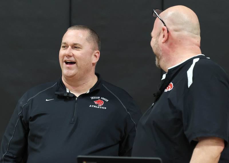 Indian Creek girls basketball head coach Paul Muchmore and athletic director Ehren Mertz share a laugh Tuesday, Feb. 10, 2026, during a cermony held before Indian Creek took on Rosary. Muchmore, the longtime coach of the Timberwolves, was being honored at his last home game before retirement from coaching at the end of the season.