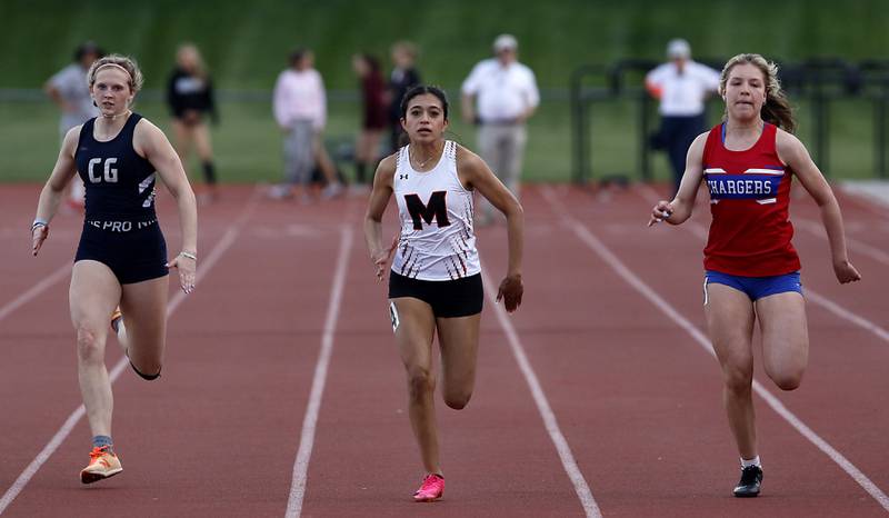 Cary-Grove’s Lindsey Kownick, McHenry’s Kelly Huerta, and Dundee-Crown’s Paulina Tinajero race to the finish line in the 100 meter dash Friday, May 5, 2023, during the Fox Valley Conference Girls Track and Field Meet at Huntley High School.