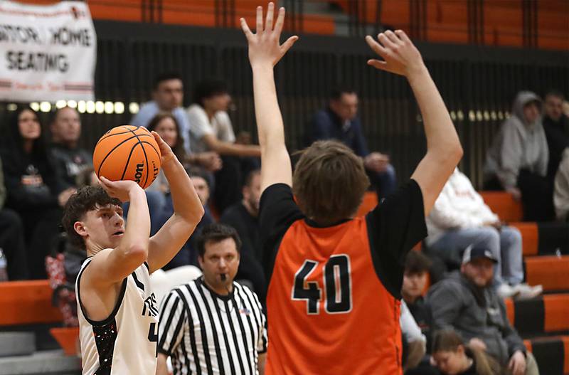 Crystal Lake Central's Bud Shanahan shoots a three-pointer in front of McHenry's Nate Ottaway during a Fox Valley Conference boys basketball game on Tuesday, February. 10, 2026, at Crystal Lake Central High School.