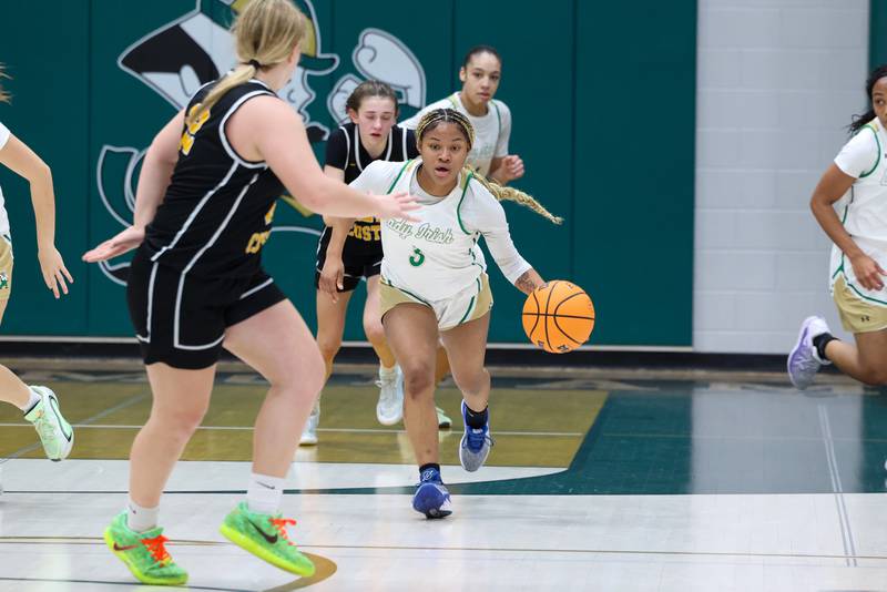 Bishop McNamara's Eliana Isom brings the ball up the court during their 60-36 victory over Reed-Custer in the IHSA Class 2A Bishop McNamara Regional semifinals on Monday, Feb. 16, 2026.