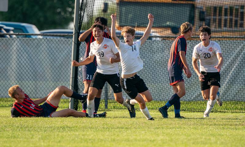 Wheaton Warrenville South's Brooks Becker (14) celebrates after scoring a goal against Oswego to tie the game in the final minute of play during a soccer match at Oswego High School on Thursday, Aug 25, 2022.
