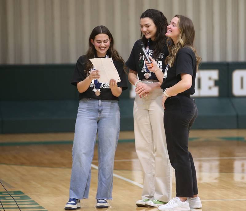 Members of the St. Bede girls basketball team react as they watch a video slideshow of their season during a celebration ceremony on Tuesday, March 5, 2024 in Abbot Vincent Gymnasium.