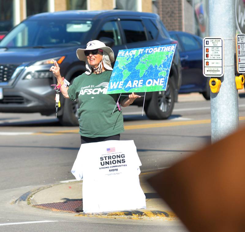 A participant in the "Workers Over Billionaires" rally in downtown Oregon holds her sign in downtown Oregon on Monday, Sept. 1, 2025.