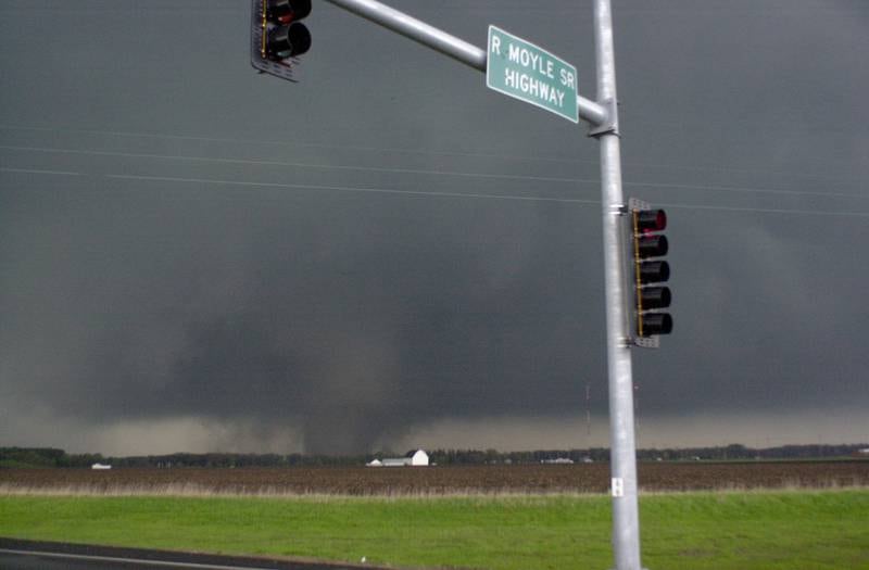 A tornado moves along the Illinios River as it crosses Illinios Route 251 near the intersection of North 25 Road on Tuesday, April 20, 2004 in Oglesby. The tornado was headed straight for the Village of Utica.