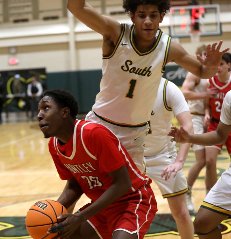 Huntley's Isaiah Onu waits for Crystal Lake South's Noah Cook to fly over him before shooting during a Fox Valley Conference boys basketball game on Friday, Jan. 30, 2026, at Crystal Lake South High School.