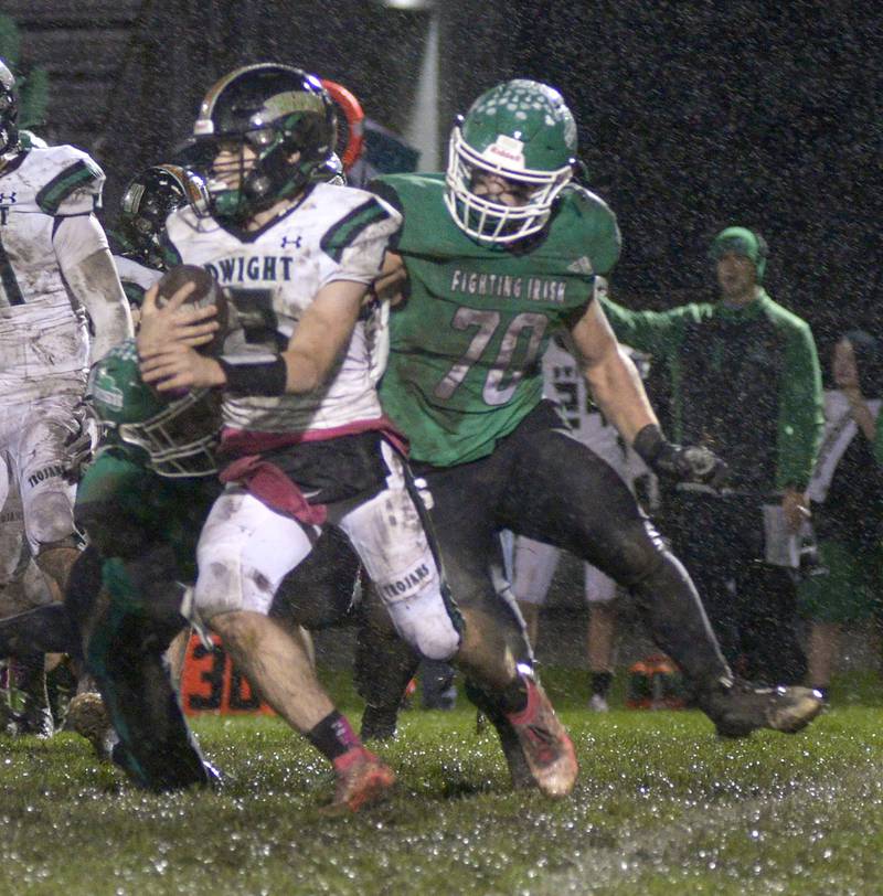 Seneca’s Chris Peura grabs hold of Dwight’s Conner Telford on a run in the 1st quarter Friday at Seneca.