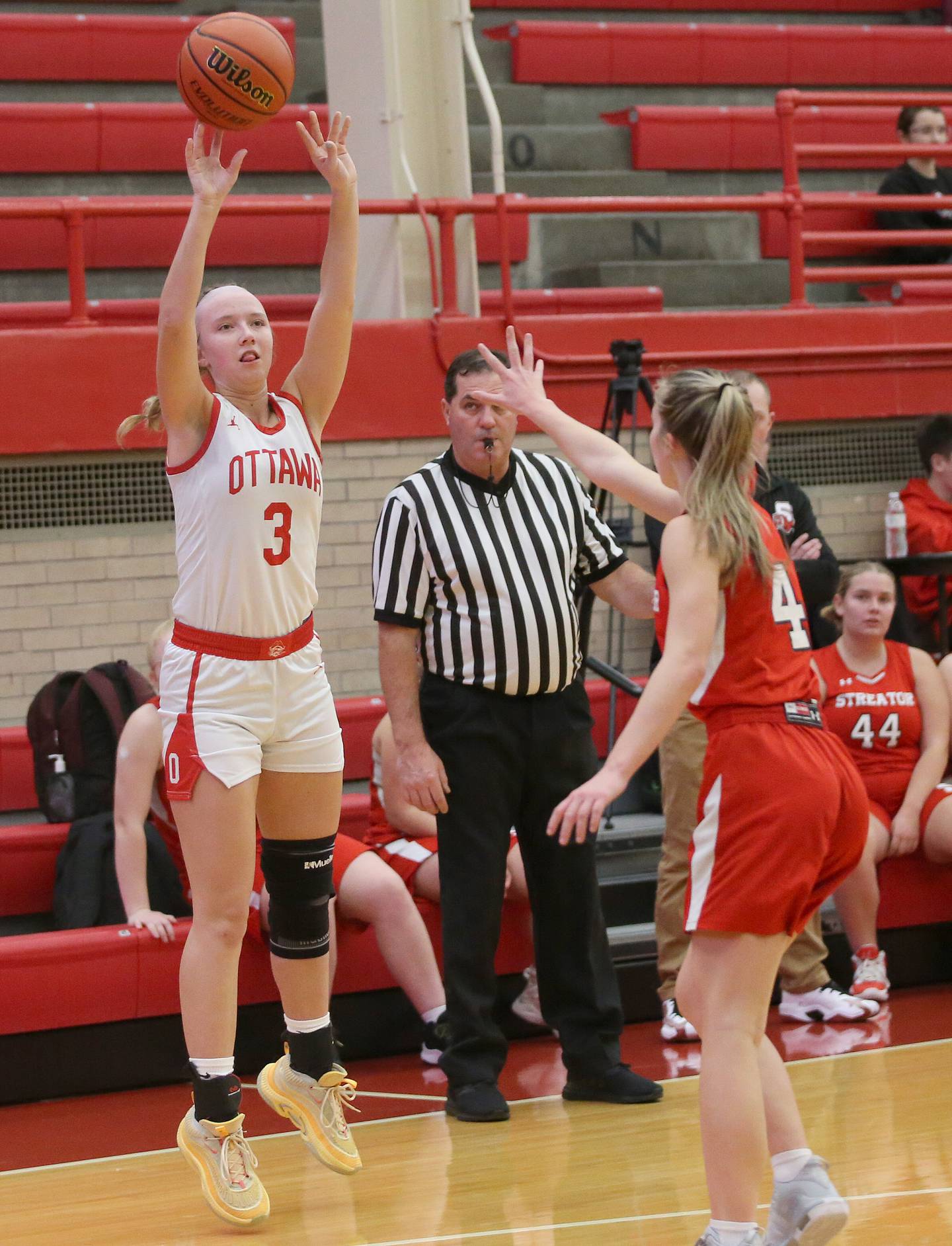 Ottawa's Skylar Dorsey shoots a three-point basket over Streator's Joey Puetz during the Lady Pirate Holiday Tournament on Wednesday, Dec. 20, 2023 in Kingman Gym.