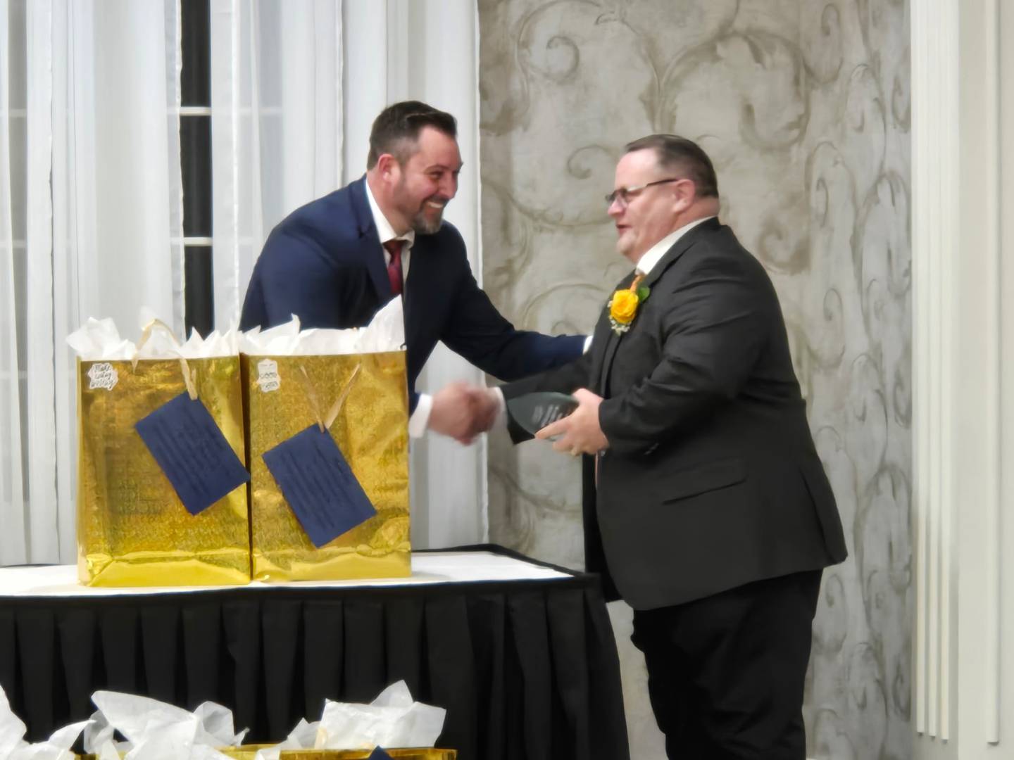 Carl Vallianatos, McHenry Community High School District 156 assistant superintendent for learning and innovation, receives the administrator of the year award from the McHenry County Regional Office of Education on Saturday, May 10, 2025.