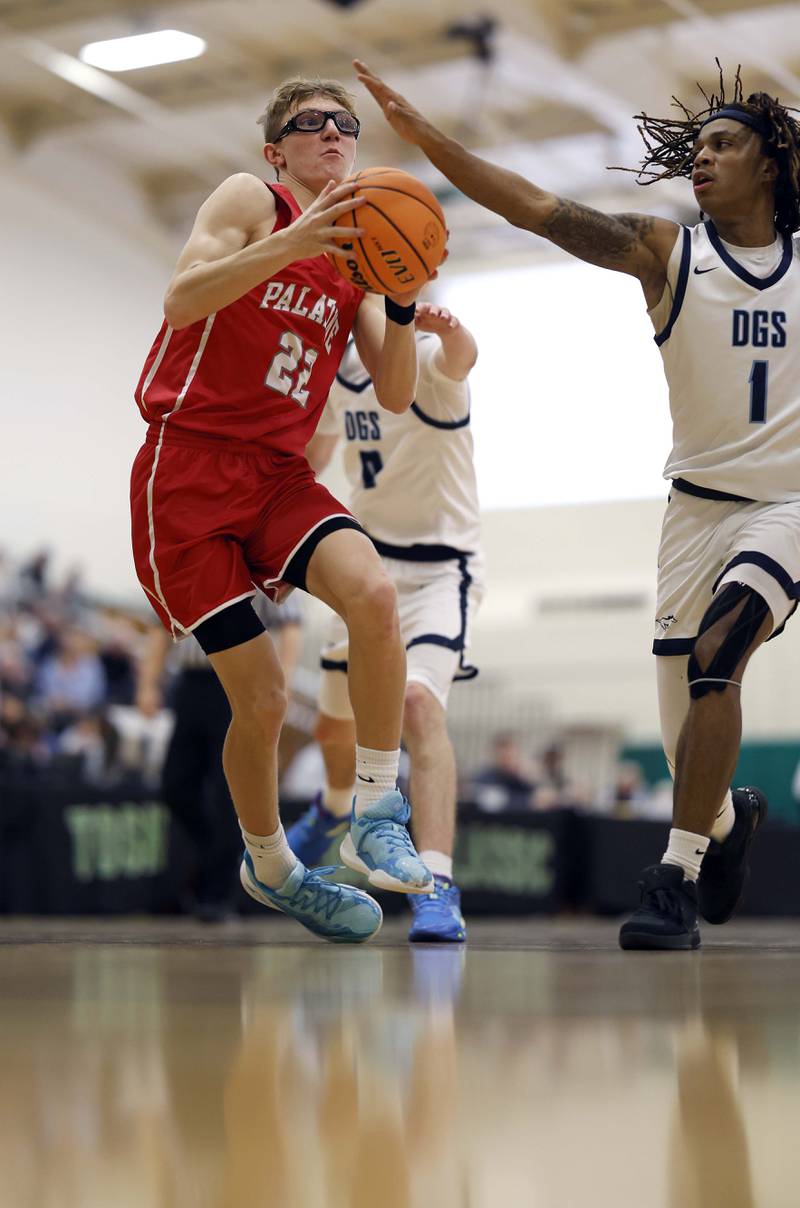 Palatine’s Darrin Dick (22) slides down the lane as Downers Grove South’s Keon Maggitt (1) pressures him during the Jack Tosh Holiday Tournament Thursday, Dec. 26, 2024 at York High School in Elmhurst.