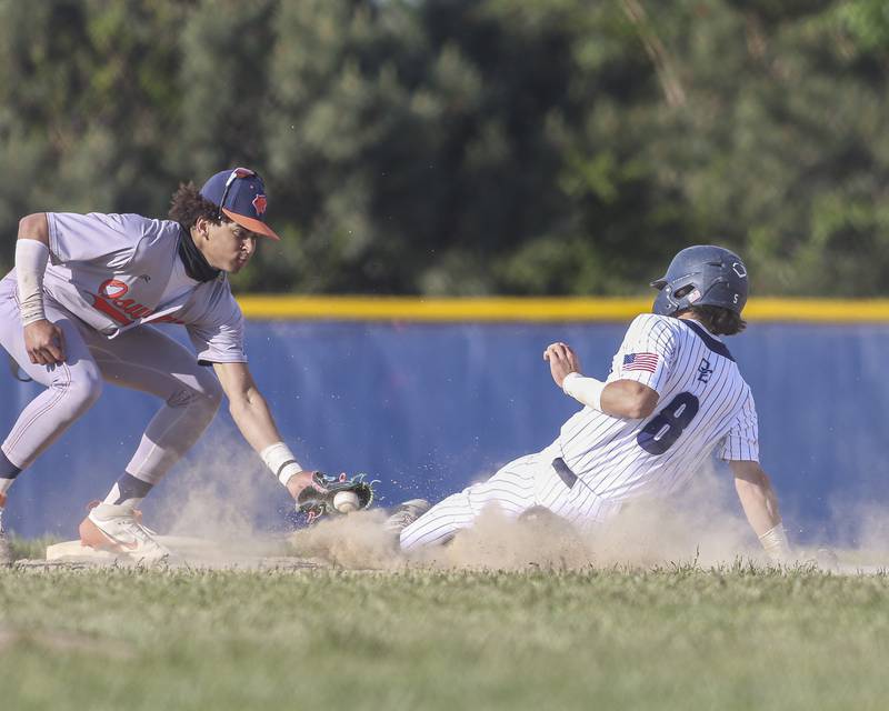 Oswego East's Niko Villacci (8) slides into the tag from Oswego's Kam Jenkins (25) at second during baseball game between Oswego East at Oswego. Monday, May 19, 2025 in Oswego.