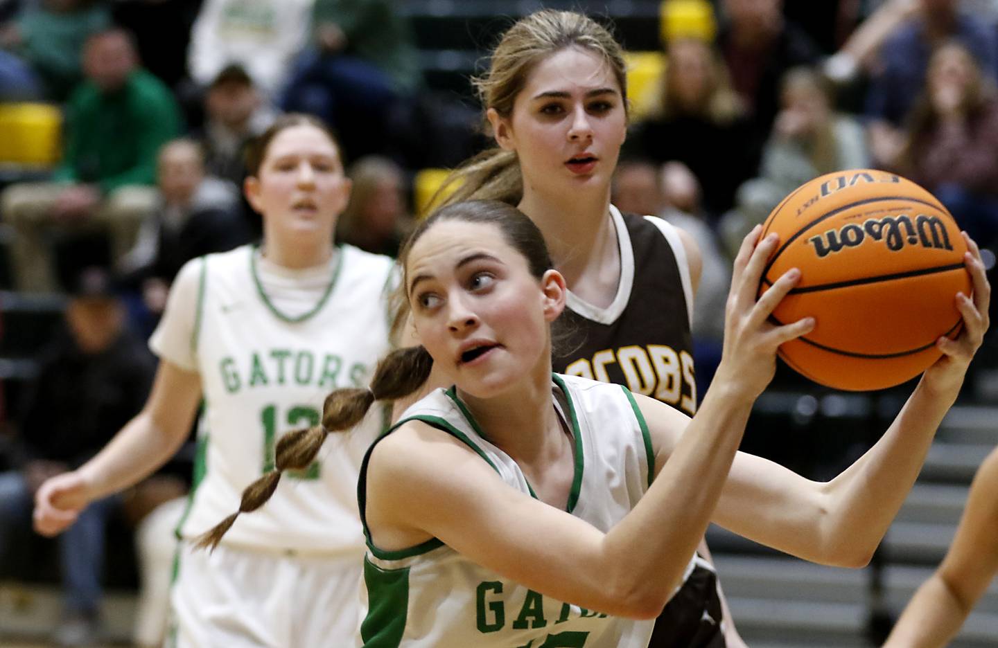 Crystal Lake South's Tessa Melhuish grabs a rebound in front of Jacobs' Olivia Schuster during a Fox Valley Conference basketball game on Friday, Jan. 17, 2025, at Crystal Lake South High School.