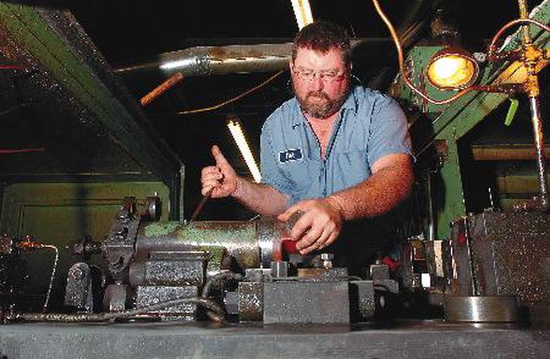 Mark Sanders, a machine operator at Hill Fastener in Rock Falls, works on a machine that makes bolts the military will use on its Humvee vehicles.