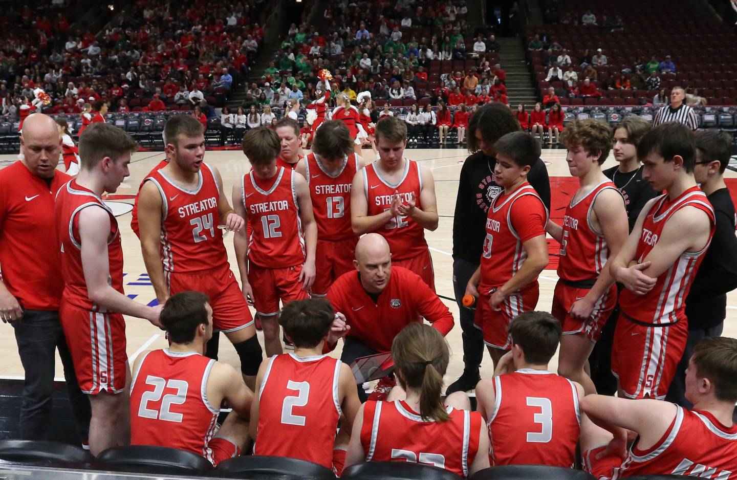 Streator head boys basketball coach Beau Doty talks to his team during a timeout Tuesday, Dec. 21, 2023, at the United Center in Chicago with assistant coach Bryan Park (far left) present.