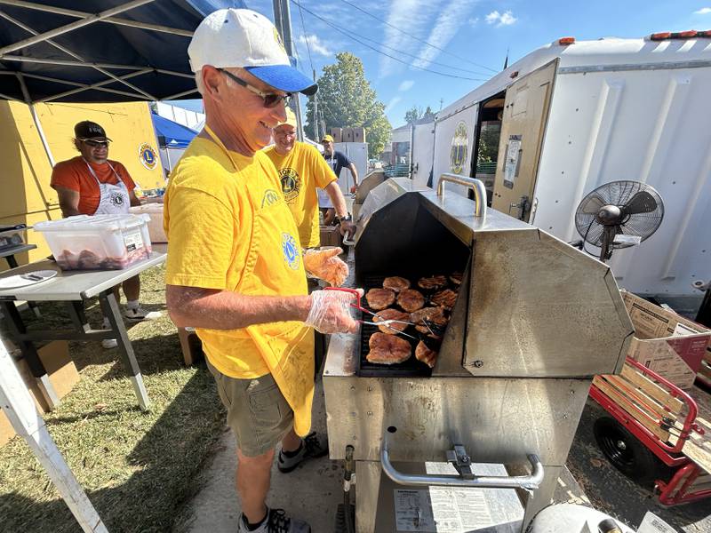 Oregon Lions Club members Grant Afflerbaugh, Doug Moser, and Tom Champley were busy grilling pork chops and bratwurst in the Autumn on Parade Food Court on Saturday, Oct. 4, 2025 in Oregon.