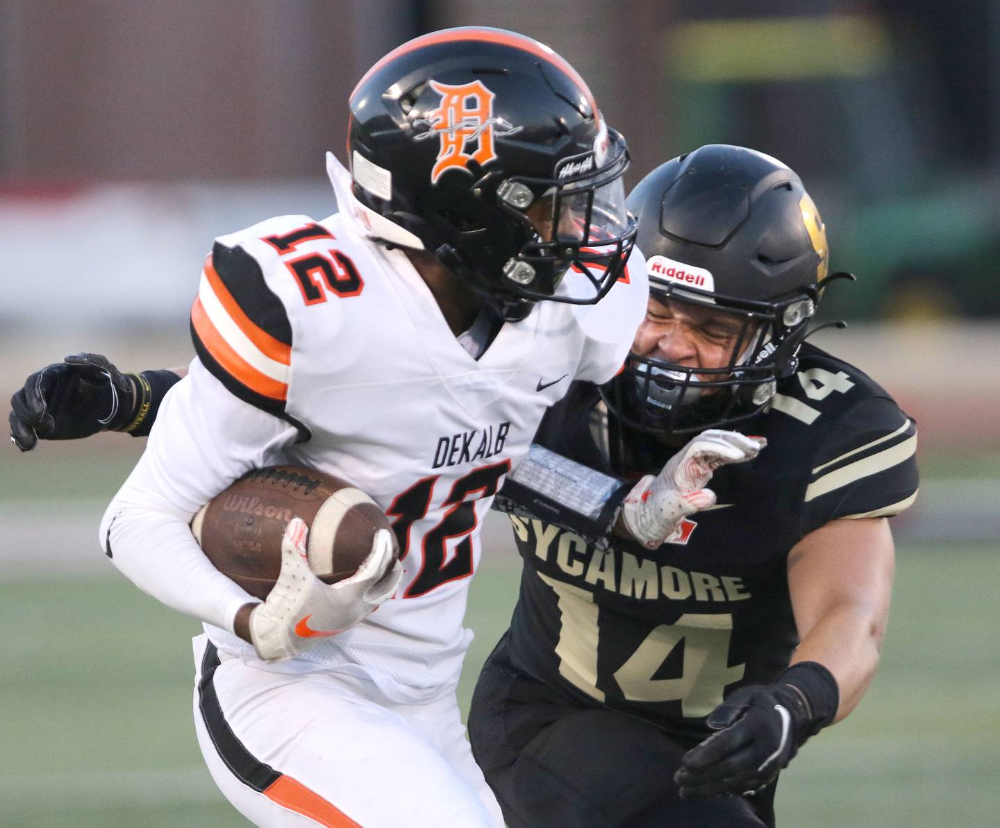 DeKalb wide receiver Ethan McCarter tries to fend of Sycamore's Kiefer Tarnoki Friday Aug. 27, 2021, during the First National Challenge in Huskie Stadium at Northern Illinois University in DeKalb. Friday was the first game of the 2021 season for both schools.
