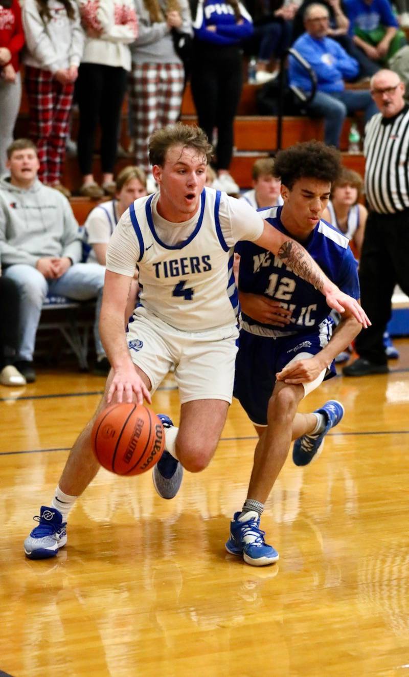 Princeton's Korte Lawson drives against Newman's Isaiah Williams Tuesday at Prouty Gym. The Tigers won 59-54.