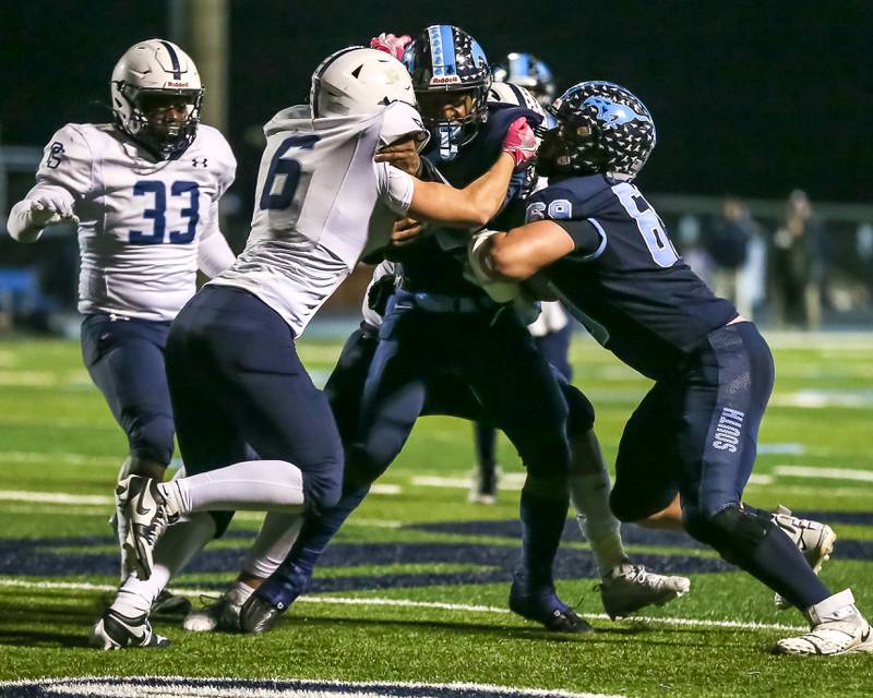 Plainfield South's Anthony Blatchford (6) helps tackle Downers Grove South's Kayden Smith (5) during Class 8A Playoff football game between Plainfield South at Downers Grove South on Friday, Nov 1, 2024  in Downers Grove.
