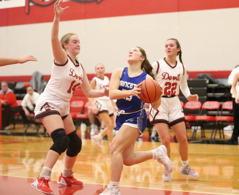 Princeton's Miyah Fox runs in the lane past Hall's Ella Sterling on Thursday, Nov. 30, 2023 at Hall High School.