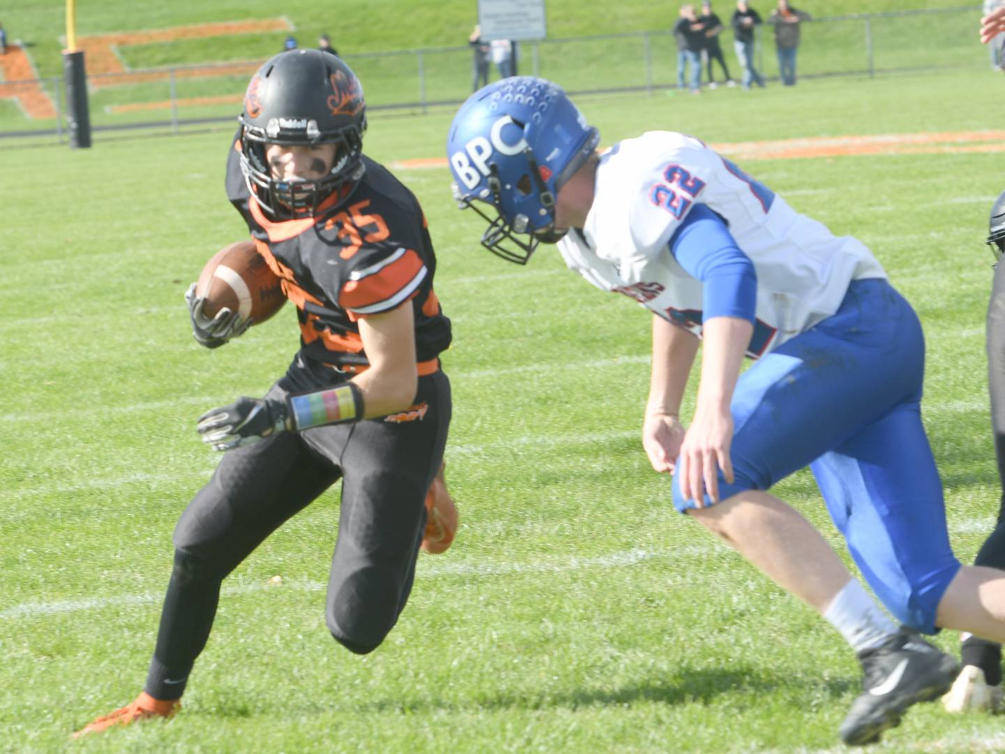 Milledgeville's Bryce McKenna heads to the end zone as he prepares for a hit from Dalton Huffman.