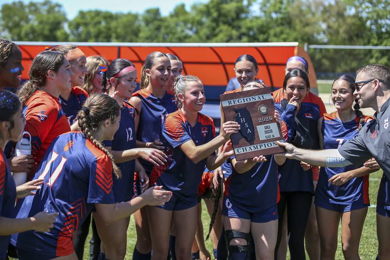 Oswego is handed the Class 3A regional final plaque after defeating Neuqua Valley on Saturday, May 23, 2026 in Oswego.