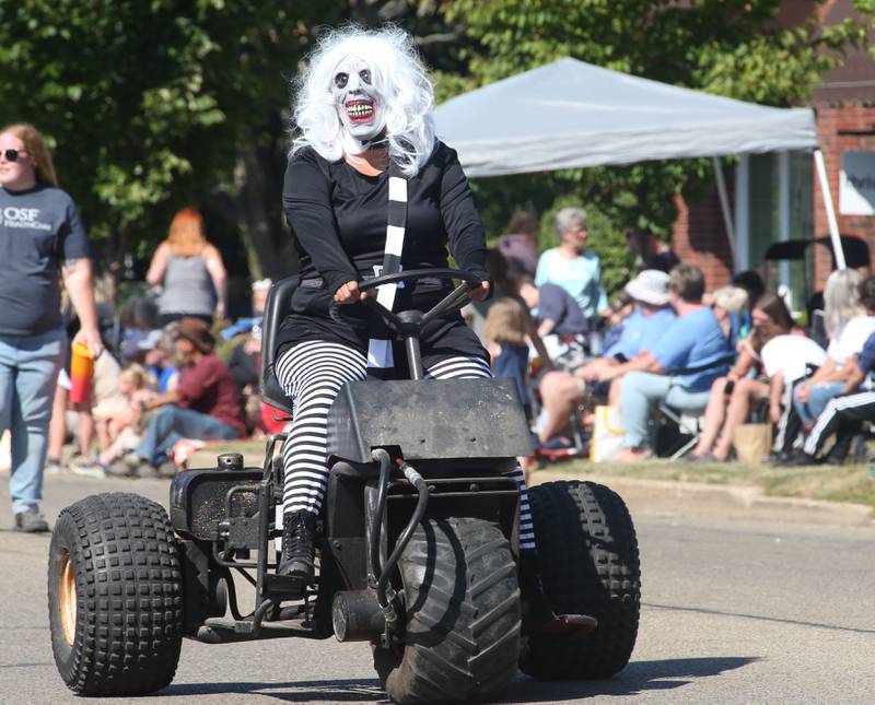 A Nightmare on Fairgrounds Road character rides a three-wheeler during the 52nd annual Homestead Festival parade on Saturday, Sept. 9, 2023 in Princeton.