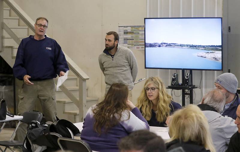 Ron Raupp, co-chairman of the McHenry County Gravel Advisory Council, (left) speaks during the McHenry County Sand and Gravel Mining Tour on Thursday, Oct. 12, 2023. The tour brought McHenry County board members, township and village officials on a four hour trip to visit operating mines on Route 23 in Marengo and to former sites now reclaimed for housing, recreation in Algonquin and Cary.