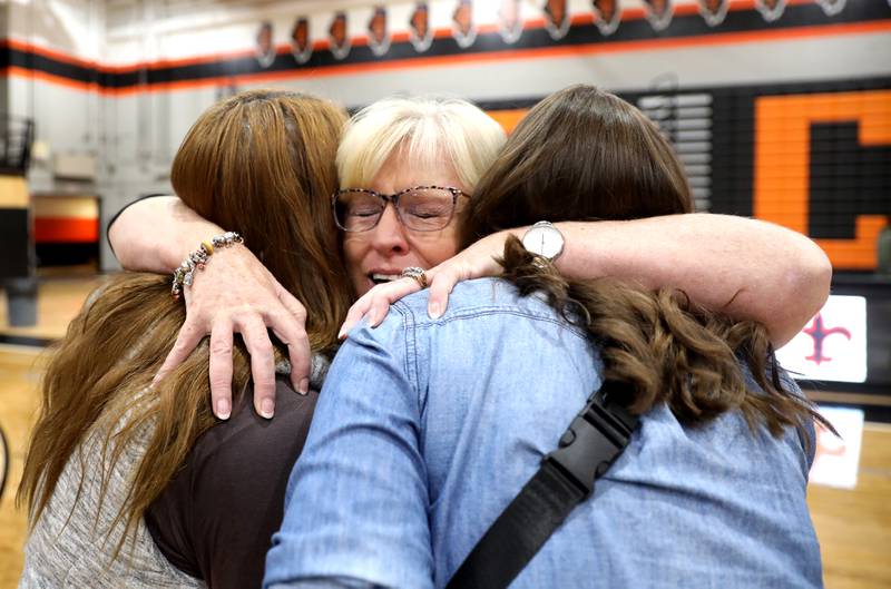 St. Charles East head girls volleyball coach Jennie Kull hugs former team members following her final regular season home game on Wednesday, Oct. 19, 2022. This is Kull’s final season at East after more than 25 years.