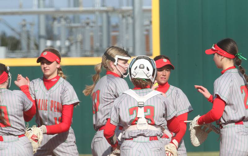 Members of the L-P softball team hi-five each other in between innings while playing Morris on Monday, April 7, 2025 at the L-P Athletic Complex in La Salle.