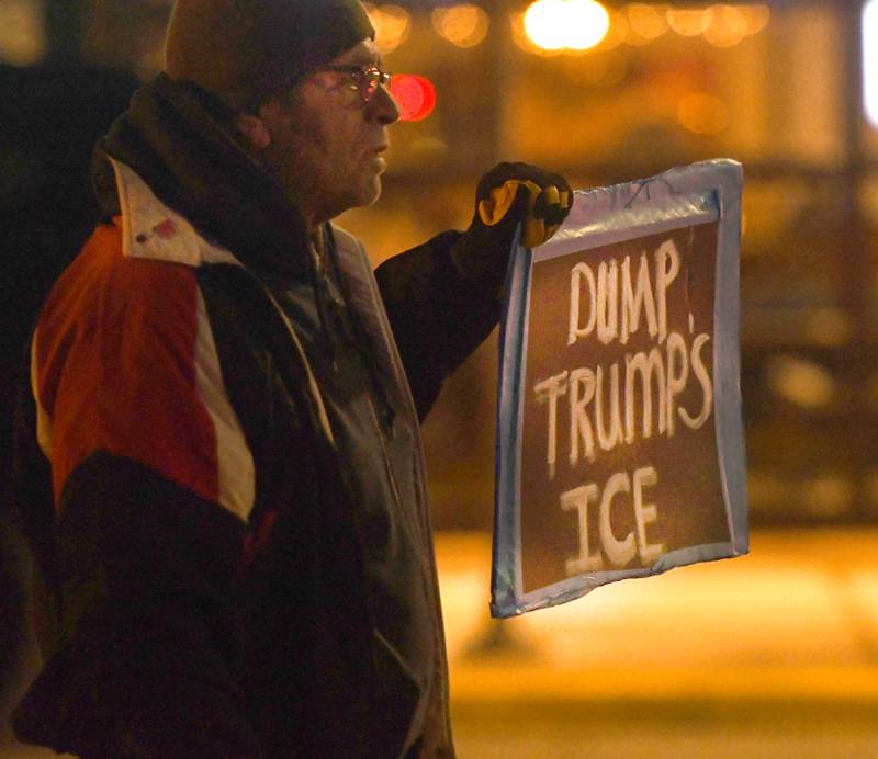A man holds a sign during a candlelight vigil in Oregon on Friday, Jan. 9, 2026 for Renee Nicole Good.