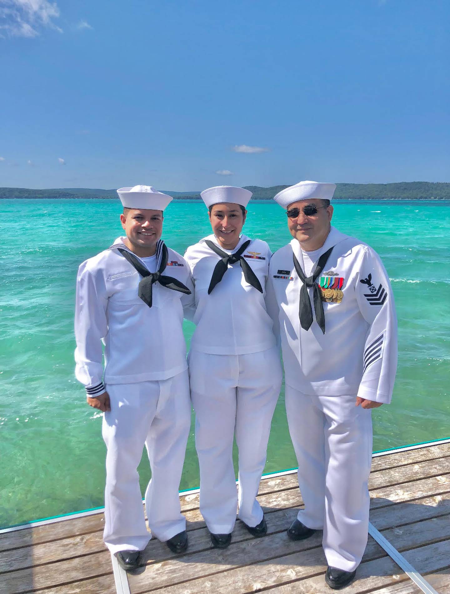 Brandyn Smith, a Navy veteran, is currently an engineer at Washington Junior High School in Joliet, and his wife Nancy Smith, a Navy veteran, is the school secretary at Eisenhower Academy in Joliet. They are posing with their father-in-law/father Jesse Smith, president of the Joliet Public Schools District 86 Board of School Inspectors.