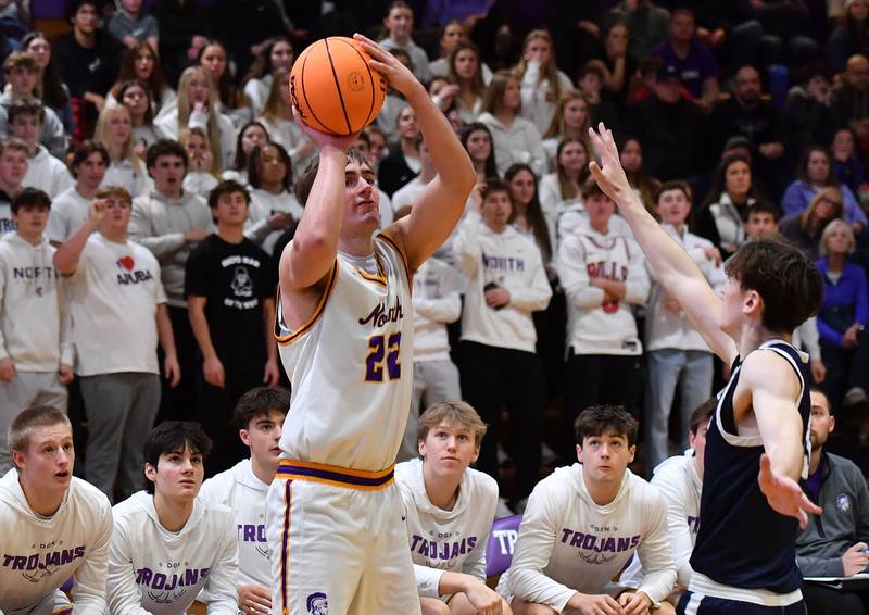 Downers Grove North’s Jacob Vroman (22) shoots for three points during a game against Downers Grove South on December 20, 2025 at Downers Grove North High School in Downers Grove.