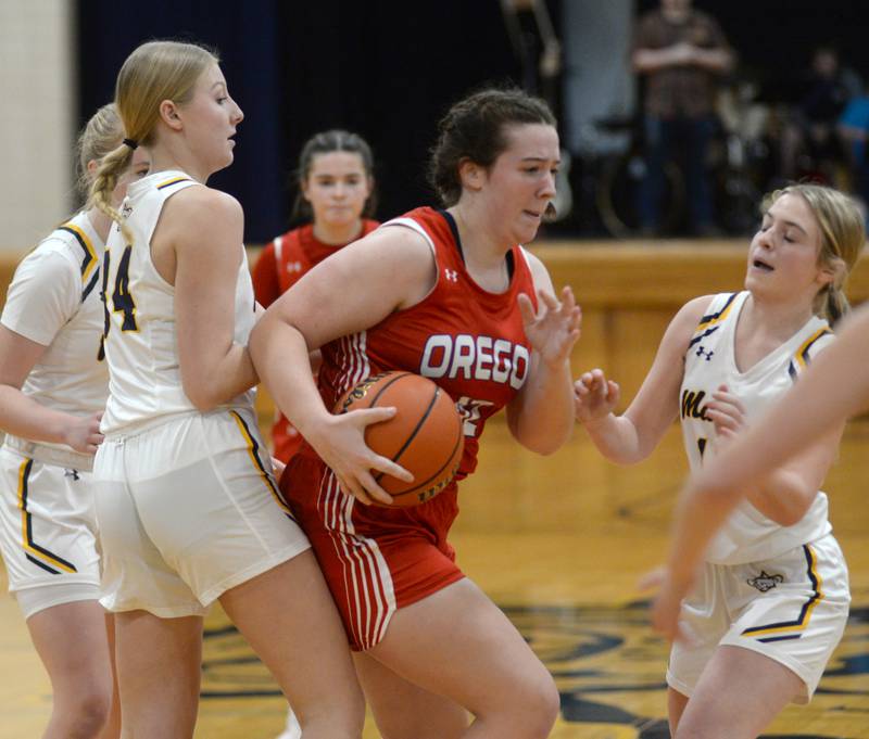 Oregon's Teagan Champley (42) battles Polo's Syndei Rahn (34) and and Madison Glawe (13) for a rebound during Tuesday, Dec. 5, 2023 action at Polo High School.