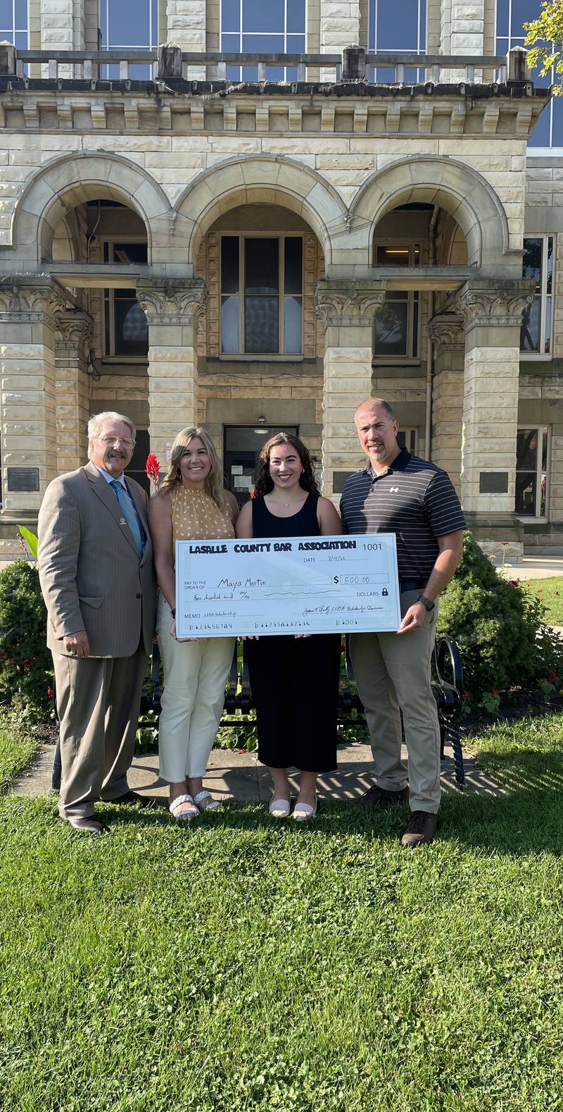 Maya Martin, of Mendota, was the recipient of a $500 scholarship sponsored by the La Salle County Bar Association. (From left) are attorney Jim Reilly, scholarship chairman, and parents Lisa and Jason Martin.