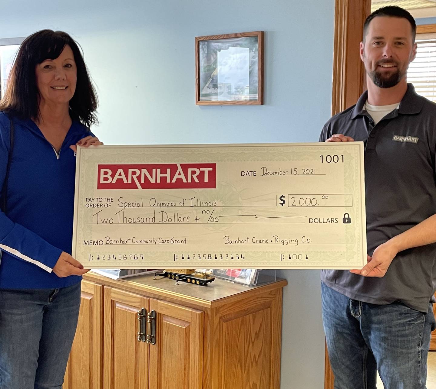 Matt Fiorentini, branch manager for Barnhart Crane and Rigging Co. in Ladd, presents a Barnhart Community Care Grant to Special Olympics of Illinois for $2,000.