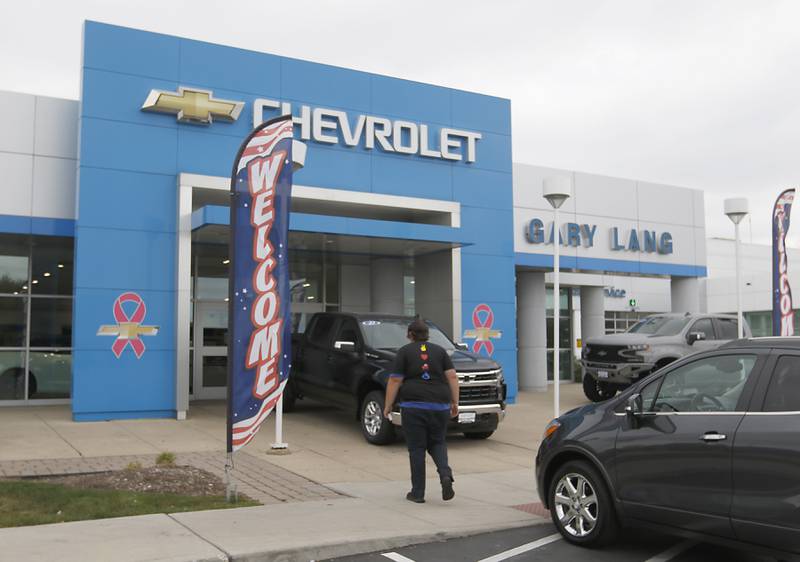 A man walks into the former Gary Lang Auto Center in McHenry on Oct. 11, 2022, The longtime McHenry Dealership was recently sold and has become the Castle Autoplex McHenry.