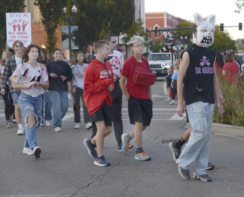 The Ottawa High School Cross Country team took a Halloween look as they march during the Homecoming Parade Wednesday evening in Ottawa.