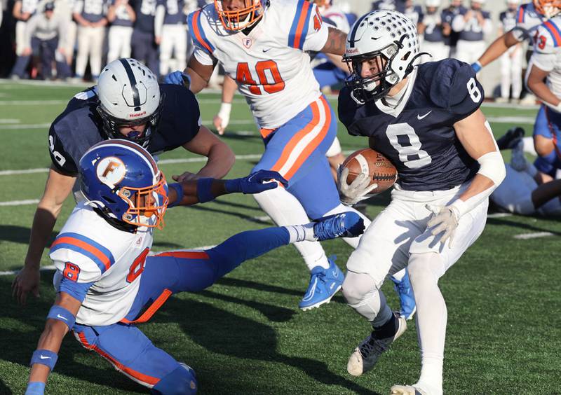 Cary-Grove's Andrew Prio looks to get by East St. Louis' Jaion Jackson Saturday, Nov. 25, 2023, during their IHSA Class 6A state championship game in Hancock Stadium at Illinois State University in Normal.