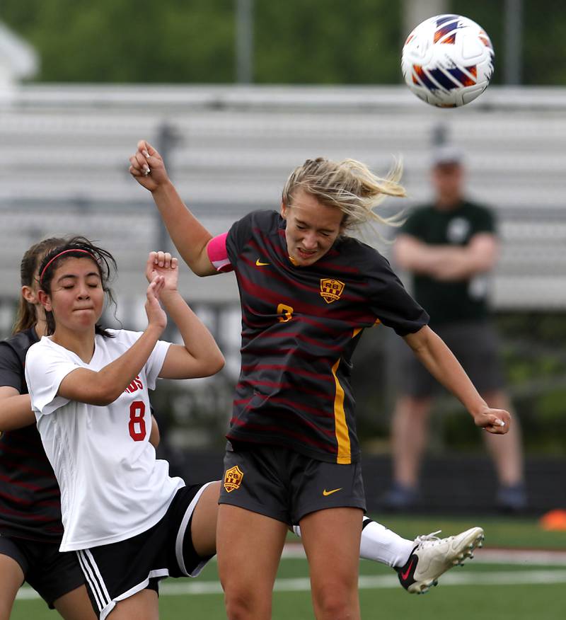 Richmond-Burton's Reese Frericks heads the ball towards the goal in front of Woodlands Academy’s Faith Guerra during a IHSA Division 1 Richmond-Burton Sectional semifinal soccer match Tuesday, May 16, 2023, at Richmond-Burton High School.