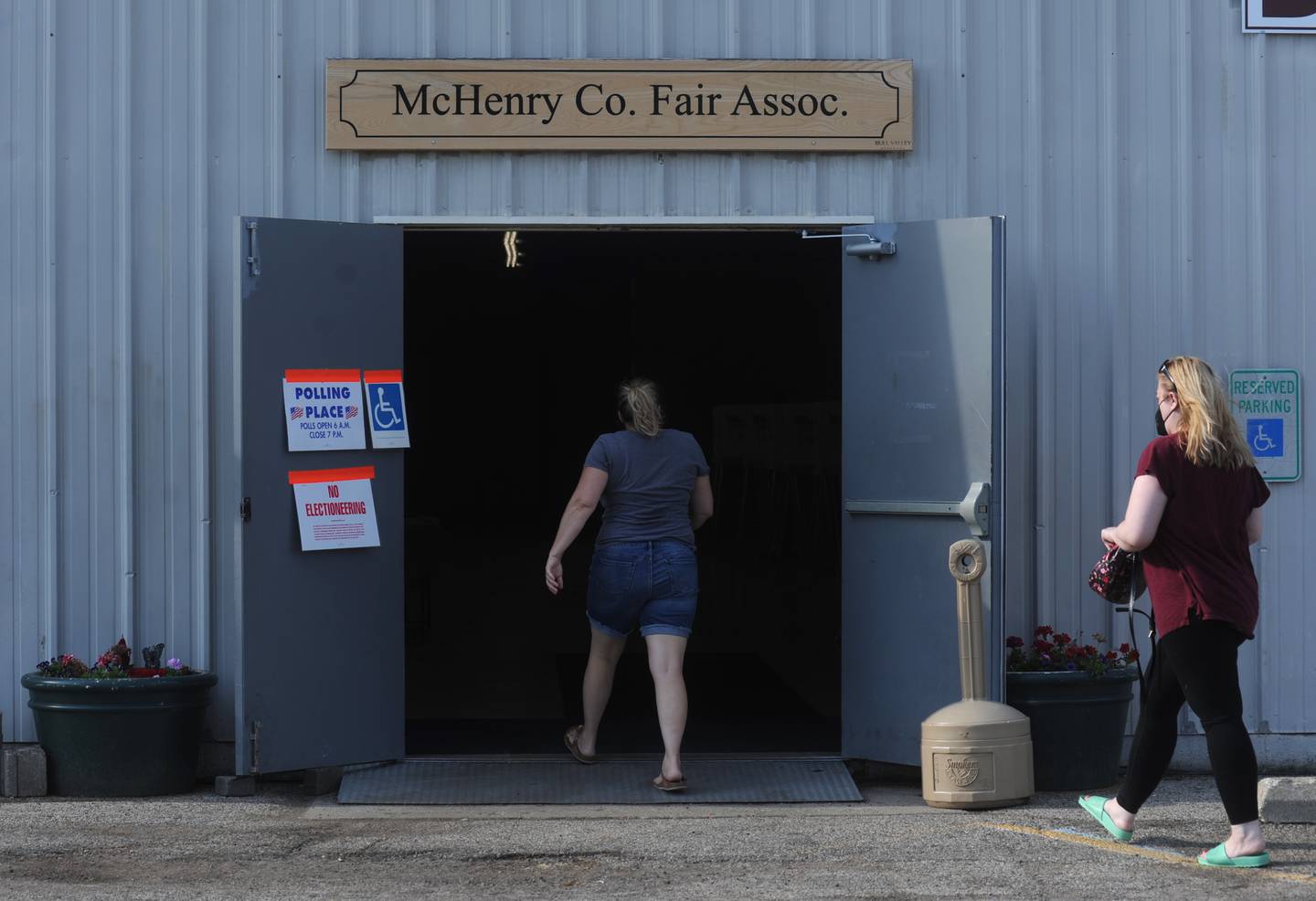 Women walk into vote into the McHenry County Fair Association Building in Woodstock to vote in the primary election on Tuesday, June 28, 2022.