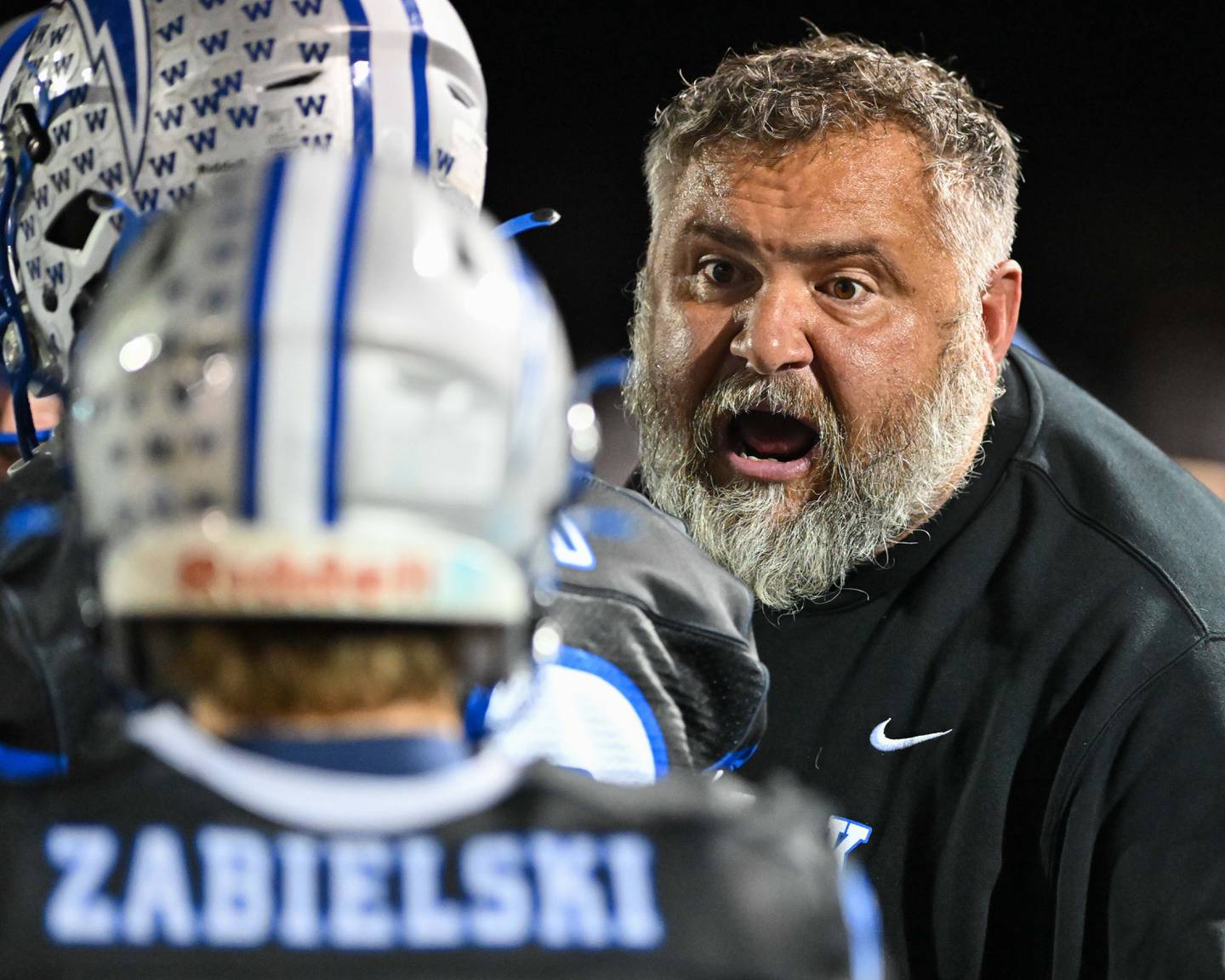 Woodstock head coach Michael Brasile talks with his team during a break in action against their Kishwaukee River Conference and crosstown rival Woodstock North on Friday, Oct. 25, 2024 at Woodstock H.S.