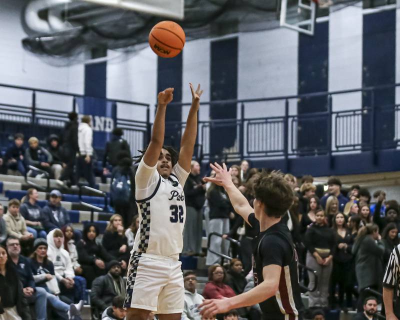 Oswego East's Alton Bullock (32) puts up a three during their basketball game between Plainfield North at Oswego East Friday, Dec 5, 2025 in Oswego.
