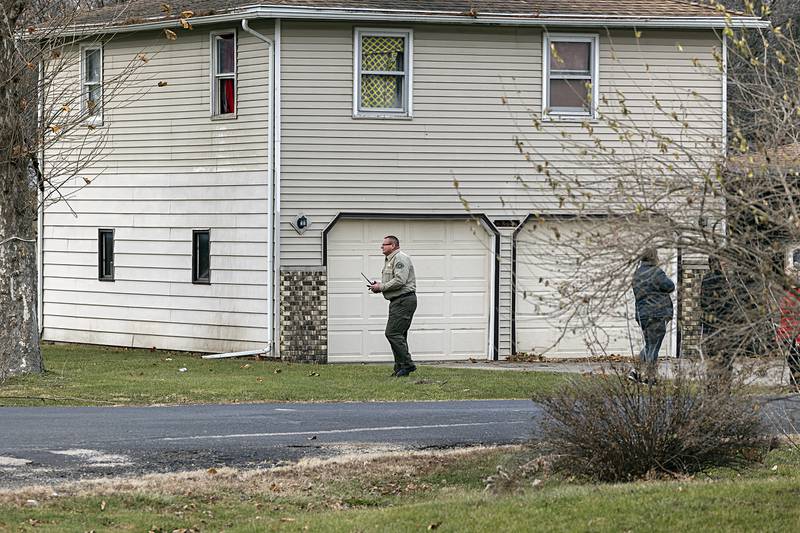 Whiteside County sheriff John Booker works at the scene of an individual who barricaded himself in a home in Yeowardsville.