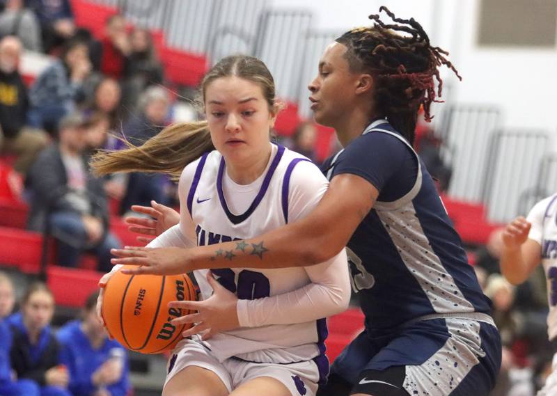 Hampshire’s Sadie Van Horn, left, works under the hoop as South Elgin’s Liv Miller defends in varsity girls basketball Komaromy Classic tournament  action on Monday, Dec. 29, 2025, at Dundee-Crown High School in Carpentersville.