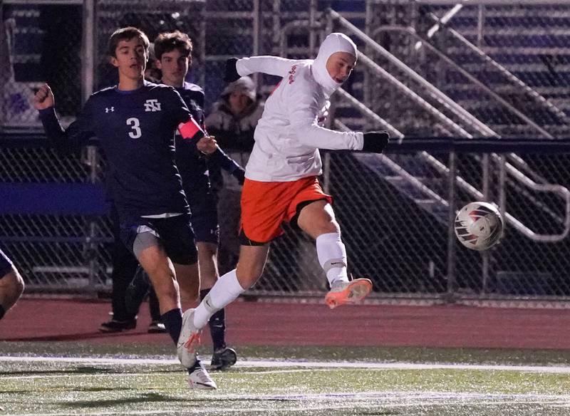 St. Charles East's Aiden Maloney (8) shoots the ball against New Trier's Liam Myers (3) during the class 3A St. Charles North Boys Soccer Supersectional match at St. Charles North High School on Wednesday, Nov. 1, 2023.
