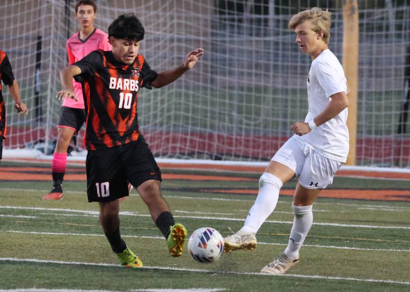 DeKalb's Matais Gutierrez and Sycamore's Gavin Crouch try to win possession during their game Thursday, Oct. 10, 2024, at DeKalb High School.