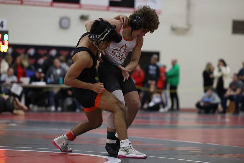 Hersey’s Esteban Delgado (left) and St. Charles East’s AJ Marino face off in the Illini Classic 120 weight championship match at Lincoln-Way Central.
